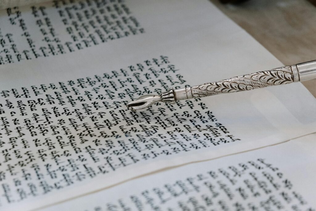 A Hebrew text with a pointer pointing at words