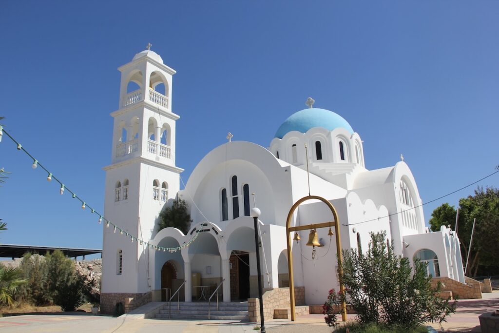 White Greek Orthodox church with a blue dome under clear sky from my trip to Greece