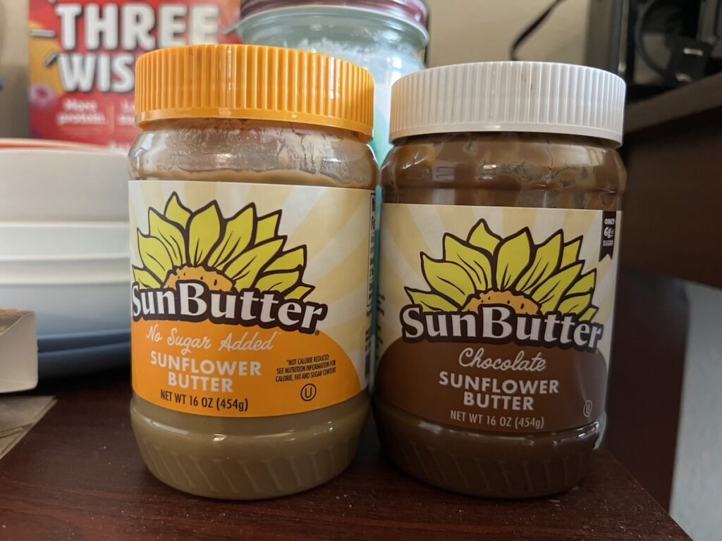 Regular no-sugar-added Sunbutter and Chocolate Sunbutter jars, ideal for allergy-friendly snacking.
