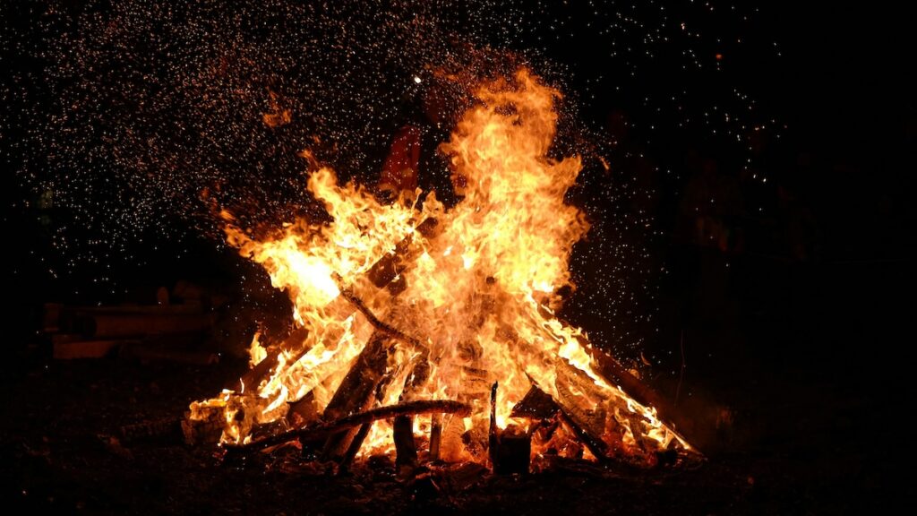 Bonfire burning brightly during a Samhain celebration in Ireland, marking the end of harvest season and beginning of winter.